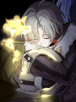 1boy closed_eyes coat commentary_request earrings fur-trimmed_coat fur_trim genshin_impact grey_hair hair_over_one_eye highres hugging_object illuga_(genshin_impact) jewelry male_focus mole mole_under_eye multicolored_hair nemineko222 red_hair single_earring solo two-tone_hair