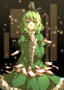 1girl black_background black_hat blush breasts closed_mouth commentary_request dress green_dress green_eyes green_hair hat highres juliet_sleeves light_particles long_sleeves looking_at_viewer nymphus ofuda ofuda_on_clothes puffy_sleeves short_hair smile soga_no_tojiko solo tate_eboshi touhou wide_sleeves