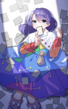 1girl absurdres belt_pouch card commentary_request covered_mouth dress feet_out_of_frame highres holding holding_card long_sleeves looking_at_viewer lying medium_hair multicolored_dress on_back patchwork_clothes pouch purple_eyes purple_hair shishidonagi solo tenkyuu_chimata touhou unconnected_marketeers