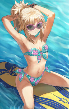 1girl armpits arms_behind_head arms_up bare_shoulders bikini blonde_hair blue_bikini bracelet braid breasts collarbone fate/grand_order fate_(series) floral_print green_eyes half_up_braid halterneck highres jewelry long_hair looking_at_viewer mordred_(fate) mordred_(swimsuit_rider)_(fate) navel ocean parted_bangs ponytail prydwen_(fate) revision sidelocks small_breasts smile solo sunglasses surfboard swimsuit thighs tonee variant_set wet