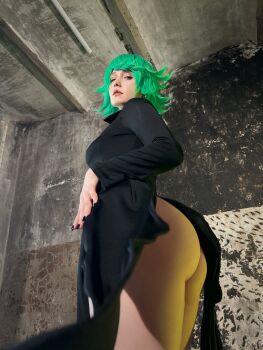 1girl ass bare_legs black_dress breasts closed_mouth cosplay curly_hair dress from_below green_hair highres jyusan lips long_sleeves looking_at_viewer looking_back one-punch_man photo_(medium) real_life saitama_(one-punch_man) short_hair standing tatsumaki tatsumaki_(cosplay) thighs