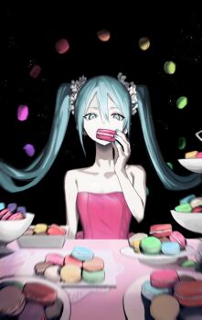 1girl aqua_eyes aqua_hair aqua_nails bare_shoulders black_background blurry breasts collarbone commentary_request dress eating food hatsune_miku highres holding holding_food macaron macaron_(vocaloid) pink_dress skinny small_breasts solo soyaka strapless strapless_dress table twintails vocaloid