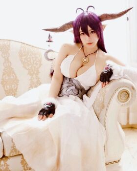 1girl asian breasts brown_eyes collar cosplay couch danua fake_horns female_focus fingerless_gloves gloves granblue_fantasy highres horns japanese_(nationality) large_breasts long_hair looking_at_viewer model on_couch photo_(medium) pointy_ears purple_hair shibuya_kaho solo