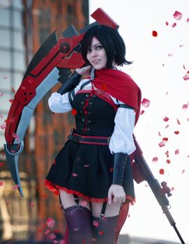1girl abi_aikou belt black_belt blurry blurry_background brown_thighhighs cosplay cosplay_photo crescent_rose dress female_focus gradient_hair grey_eyes highres holding holding_scythe long_sleeves looking_at_viewer multicolored_hair petals photo_(medium) real_life red_hair rose_petals ruby_rose ruby_rose_(cosplay) rwby scythe short_dress solo thighhighs zettai_ryouiki