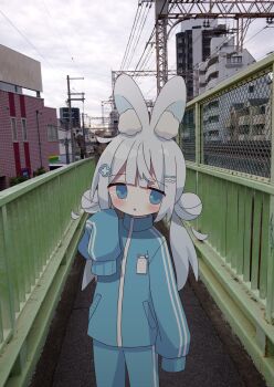 1girl animal_ear_fluff animal_ears blue_eyes blue_jacket blue_pants cloud double_bun double_vertical_stripe hair_bun hair_ornament hairclip highres jacket long_sleeves looking_at_viewer nakkar original outdoors pants parted_lips photo_background rabbit_ears rabbit_girl sleeves_past_fingers sleeves_past_wrists solo track_pants track_suit twintails