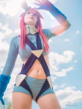1girl blue_sky breasts cloud cosplay cosplay_photo crop_top gloves long_hair long_sleeves looking_up nintendo photo_(medium) platine.cosplay pokemon pokemon_bw real_life red_hair shorts sky skyla_(pokemon) skyla_(pokemon)_(cosplay) sunlight