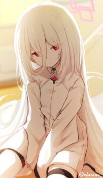 1girl baram between_legs blue_archive blurry blurry_background closed_mouth commentary_request depth_of_field dress eyes_visible_through_hair hair_between_eyes halo hand_between_legs highres kei_(blue_archive) kei_(new_body)_(blue_archive) long_hair long_sleeves looking_at_viewer red_eyes sitting sleeves_past_wrists solo thighhighs twitter_username very_long_hair white_dress white_hair white_thighhighs