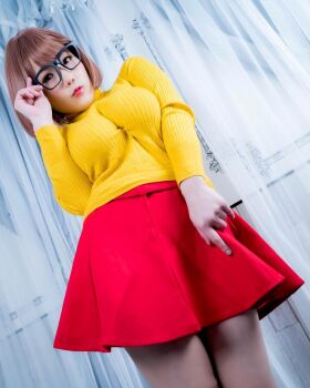 1girl breasts brown_eyes brown_hair cosplay female_focus glasses highres large_breasts looking_at_viewer medium_hair model photo_(medium) scooby-doo shibuya_kaho solo velma_dinkley velma_dinkley_(cosplay) wig