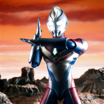 1boy absurdres alien armor blue_skin breastplate canyon color_timer colored_skin commentary compound_eyes cowboy_shot crossed_wrists crystal dorsal_fin figure_(medium) forehead_jewel giant giant_male glowing glowing_eyes gradient_sky hands_up highres looking_ahead love894anon male_focus mars_(planet) multicolored_skin no_pupils orange_sky outdoors pectorals photo_(medium) red_skin sh_figuarts silver_skin sky solo standing tokusatsu toned toned_male ultra_beam ultra_series ultraman_dyna ultraman_dyna_(flash_type) ultraman_dyna_(series) white_eyes wrinkled_skin