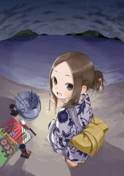 1girl :d absurdres alternate_hairstyle beach brown_hair child fireworks fisheye from_above from_behind highres holding holding_fireworks japanese_clothes karakai_jouzu_no_takagi-san kimono looking_at_viewer looking_back night night_sky ocean open_mouth sandals senkou_hanabi sky smile solo sparkler squatting star_(sky) takagi-san yamamoto_souichirou zouri