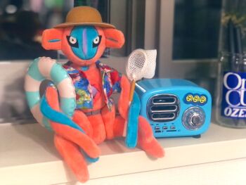 character_doll deoxys deoxys_(normal) doll full_body gen_3_pokemon hat highres indoors looking_at_viewer mythical_pokemon nintendo no_humans photo_(medium) pokemon pokemon_(creature) real_life sitting solo sun_hat tentacles what