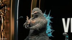 1boy 2024 3d academy_award_of_merit the_academy_awards animated award claws congratulations dinosaur english_text facial_scar godzilla godzilla_(series) godzilla_minus_one holding holding_trophy hollywood kaiju looking_up monster multiple_views nelzonis2 night no_humans photo_(medium) real_life ribbon scar scar_on_cheek scar_on_chest scar_on_face sharp_teeth smoke sound spikes standing teeth toho trophy turnaround video