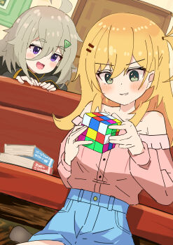 2girls :d absurdres ahoge blonde_hair blue_shorts blush book bright_pupils collarbone commentary_request green_eyes grin hair_between_eyes hibi_wa_sugiredo_meshi_umashi higa_tsutsuji highres holding hoshi_nana indoors inkr9634 long_hair long_sleeves looking_down multiple_girls off-shoulder_shirt off_shoulder open_mouth pink_shirt purple_eyes rubik's_cube shirt shorts smile teeth white_pupils