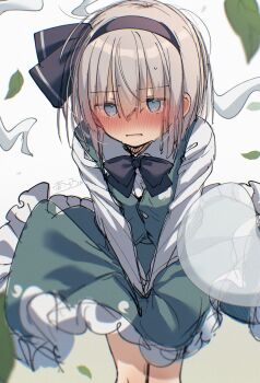 1girl black_bow black_bowtie black_hairband blue_eyes blush bow bowtie collared_shirt commentary_request embarrassed falling_leaves frilled_skirt frills green_skirt green_vest grey_hair hairband highres hitodama hitodama_print konpaku_youmu konpaku_youmu_(ghost) leaf looking_at_viewer otowa_(otoha4634) shirt signature skirt skirt_set skirt_tug solo sweat touhou vest white_shirt wind wind_lift