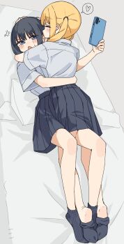 2girls absurdres anger_vein arm_around_waist black_hair black_skirt black_socks blonde_hair blue_eyes breasts closed_eyes collared_shirt commentary_request ear_licking highres holding holding_phone hug kopaka_(karda_nui) licking multiple_girls on_bed original phone pillow pleated_skirt school_uniform shirt skirt small_breasts socks twintails white_shirt yuri