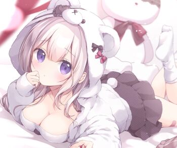 1girl animal_ears animal_hood bear_ears bear_hood bear_tail breasts cleavage closed_mouth collarbone commentary_request eyepatch fake_animal_ears fake_tail grey_hair heart heart_eyepatch highres hood hood_up hooded_jacket jacket long_hair long_sleeves looking_at_viewer lying medium_breasts miyasaka_naco no_shoes on_stomach original puffy_long_sleeves puffy_sleeves purple_eyes sleeves_past_wrists socks soles solo stuffed_animal stuffed_rabbit stuffed_toy tail white_jacket white_socks