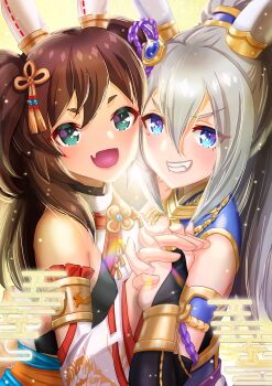 2girls animal_ears bare_shoulders brown_hair commentary_request ear_covers ear_ornament egasumi fang gold_trim grey_hair grin hair_between_eyes hair_ornament highres holding_hands horse_ears horse_girl inari_one_(fields_of_gold)_(umamusume) inari_one_(umamusume) long_hair multiple_girls official_alternate_costume official_alternate_hairstyle open_mouth otono_(bkt4b) ponytail skin_fang smile tamamo_cross_(fierce_thunder_god)_(umamusume) tamamo_cross_(umamusume) tassel tassel_hair_ornament thick_eyebrows twintails umamusume v-shaped_eyebrows