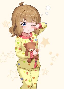 1girl absurdres ahoge arm_up blue_eyes blush brown_hair feet_out_of_frame highres holding holding_stuffed_toy idolmaster idolmaster_million_live! long_sleeves looking_at_viewer one_eye_closed pajamas pants parted_lips print_pants print_shirt puzzle_piece_print shirt short_hair solo standing stuffed_animal stuffed_toy suou_momoko tanukiinu005 teddy_bear yellow_pants yellow_shirt