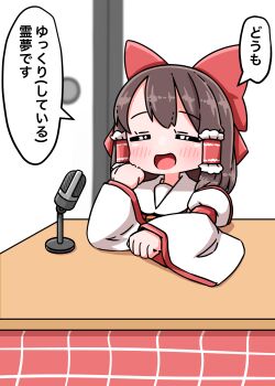 1girl blush bow brown_hair closed_eyes commentary_request detached_sleeves frilled_hair_tubes frills fusuma hair_bow hair_tubes hakurei_reimu highres kotatsu long_hair microphone open_mouth red_bow roco_(katsuya1011) sliding_doors smile solo speech_bubble table touhou translation_request under_kotatsu under_table