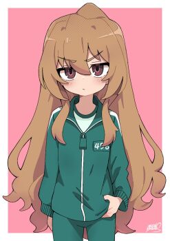 1girl aisaka_taiga blush brown_eyes brown_hair green_jacket green_pants jacket jitome koonowen long_hair long_sleeves looking_at_viewer pants pink_background signature solo squid_game toradora! track_jacket track_pants v-shaped_eyebrows very_long_hair