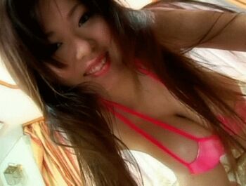 2007 animated animated_gif arms_up asian bikini bouncing_breasts breast_focus breasts brown_hair gravure_idol hanging_breasts huge_breasts jcf-12 jiggle long_hair miyabi_isshiki photo_(medium) pink_bikini real_life smile swimsuit