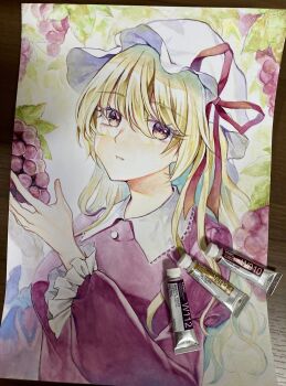 1girl absurdres art_tools_in_frame blonde_hair buttons collared_shirt commentary food frilled_sleeves frills fruit grapes hat hat_ribbon head_tilt highres kaede_(mmkeyy) long_hair looking_at_viewer maribel_hearn mob_cap open_mouth paint painting_(medium) photo_(medium) purple_shirt red_ribbon ribbon shirt solo teeth touhou traditional_media upper_body watercolor_(medium) white_hat yellow_eyes