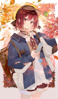 1girl absurdres alternate_costume anachronism atelier_(series) atelier_sophie autumn_leaves backpack bag blue_jacket border brown_shorts cellphone commentary_request cowboy_shot dappled_sunlight flip_phone hand_up hat head_tilt highres holding holding_phone jacket jewelry leaf looking_at_viewer necklace nekoolantern open_mouth outdoors phone red_eyes red_hair shirt short_hair shorts smile solo sophie_neuenmuller sunlight white_border white_shirt yellow_hat