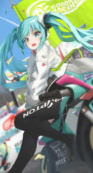 1girl absurdres aqua_eyes aqua_hair asymmetrical_legwear black_bodysuit black_gloves black_thighhighs blue_sky blurry blurry_background bodysuit commentary covered_navel flag foot_out_of_frame gloves goodsmile_company goodsmile_racing hair_between_eyes hair_ornament hatsune_miku highres jacket long_hair looking_at_viewer open_mouth outdoors racing_miku racing_miku_(2022) remi_(allekusu) single_thighhigh sky solo thighhighs twintails very_long_hair vocaloid white_jacket