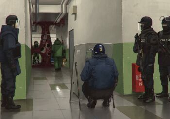 balaclava ballistic_shield black_footwear black_gloves body_armor bomb_suit boots bulletproof_vest circular_saw door eldritch_abomination extra_eyes full_body glasses gloves gun gun_sling hallway helmet highres holding holding_gun holding_weapon horror_(theme) indoors industrial_pipe japan_national_police long_sleeves monster multiple_boys noinh original police police_uniform policeman power_tool realistic reflective_floor restrained riot_helmet saw shield shotgun squatting standing submachine_gun tactical_clothes teeth tile_floor tiles visor_(armor) waiting weapon