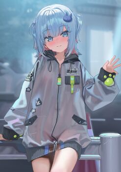 1girl arm_support blue_eyes blue_hair blurry blurry_background blush closed_mouth colored_inner_hair commentary_request grey_jacket highres hood hood_down hooded_jacket indie_virtual_youtuber jacket kanzarin kanzarin_(vtuber) long_sleeves looking_at_viewer multicolored_hair pink_hair puffy_long_sleeves puffy_sleeves see-through_clothes see-through_jacket smile solo two_side_up virtual_youtuber waving