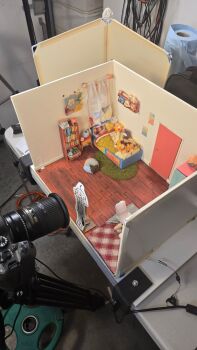 1girl bed bedroom book bookshelf camera carpet chair commentary curtains diorama_(medium) door english_commentary gigi_murin highres hololive hololive_english i&#039;ll_still_be_here izzy_delore making-of office_chair official_art photo_(medium) pillow poster_(object) shelf solo standee stuffed_animal stuffed_toy swivel_chair tripod unconventional_media virtual_youtuber