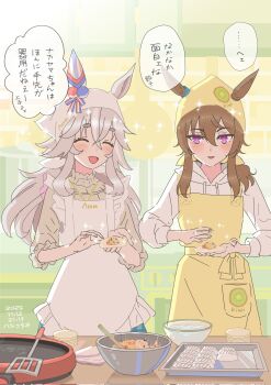2girls animal_ears apron blush bowl breasts brown_hair closed_eyes dumpling ear_covers ear_ornament ears_through_headwear food fruit grey_hair grey_shirt hair_between_eyes hashikurao headscarf highres holding hood hood_down hoodie horse_ears horse_girl jewelry kitchen kiwi_(fruit) kiwi_slice long_hair long_sleeves multicolored_hair multiple_girls nakayama_festa_(umamusume) necklace open_mouth purple_eyes shirt single_ear_cover smile spatula speech_bubble streaked_hair tray umamusume white_apron white_headscarf white_hoodie wonder_acute_(umamusume) yellow_apron yellow_headscarf