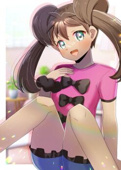 1girl :d black_bow black_scrunchie blue_shorts blurry blurry_background blush bow brown_hair commentary_request commission dark-skinned_female dark_skin depth_of_field feet_out_of_frame frilled_shorts frills green_eyes hair_between_eyes hand_up head_tilt knees_together_feet_apart knees_up kou_hiyoyo long_hair looking_at_viewer nintendo open_mouth pink_shirt pokemon pokemon_xy scrunchie shauna_(pokemon) shirt short_sleeves shorts sitting skeb_commission smile solo twintails