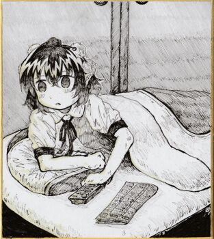 1girl black_hair blanket commentary_request controller dade_ne futon grey_background greyscale highres lying monochrome newspaper on_stomach pillow remote_control shameimaru_aya solo touhou