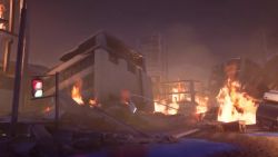 animated blue_electricity building car city copyright_name cross_promotion crossover destruction dinosaur electricity embers energy epic epic_games fighting_game fire game_trailer gigabash glowing glowing_spikes godzilla godzilla_(series) highres kaiju logo motor_vehicle night no_humans passion_republic_games road_sign roaring sea_monster sign silhouette smoke sony sound spikes steam_(platform) tail teaser teaser_trailer toho traffic_light trailer_(media) tree truck video video_game