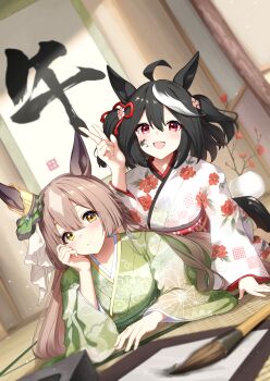 2girls absurdres animal_ears arm_support black_hair black_tail blush brown_eyes brown_hair calligraphy_brush closed_mouth commentary_request ear_ornament floral_print floral_print_kimono green_kimono hair_between_eyes hair_ornament hand_on_own_cheek hand_on_own_face highres horse_ears horse_girl indoors ink ink_on_face japanese_clothes kakizome kimono kitasan_black_(umamusume) light_particles long_hair looking_at_viewer lying multicolored_hair multiple_girls on_stomach open_mouth paintbrush print_kimono red_eyes satono_diamond_(umamusume) scroll short_hair smile streaked_hair sunny_(20597521) tatami two_side_up umamusume w white_hair white_kimono white_streaks